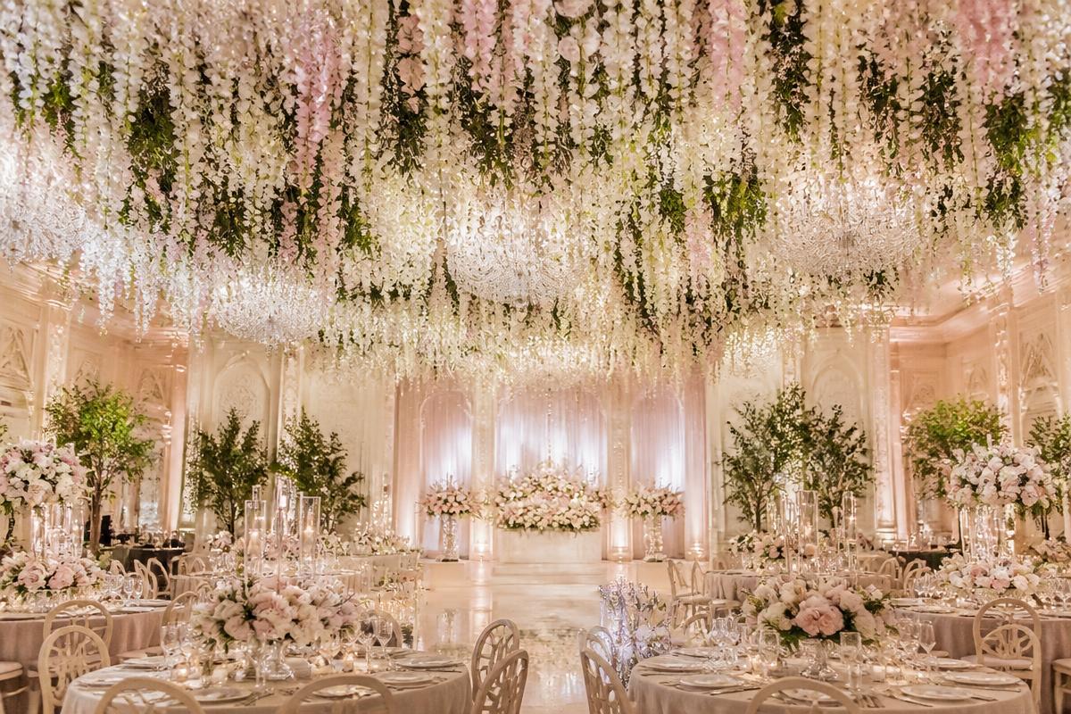 Elegant grand event hall with soft floral ceiling installation